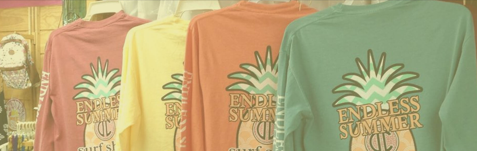 long sleeve shirts hanging on rack with endless summer logo on the back