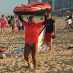 endless summer instructor holding inner tube above her head