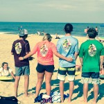 group of four showing the back of their endless summer shirts