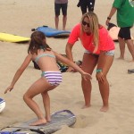young girl being taught to surf in ocean city md