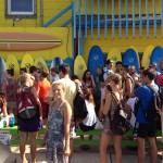 large group waiting outside endless summer surf shop