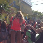 girl carrying back pack stepping off endless summer fence