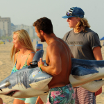 Surf instructors holding an inflatable shark in Ocean City md